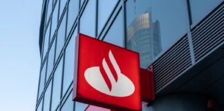Sign with logo for Santander Bank, which has a red background and a stylized abstract image of a white swan. The sign is bolted toward the base of a skyscraper building.