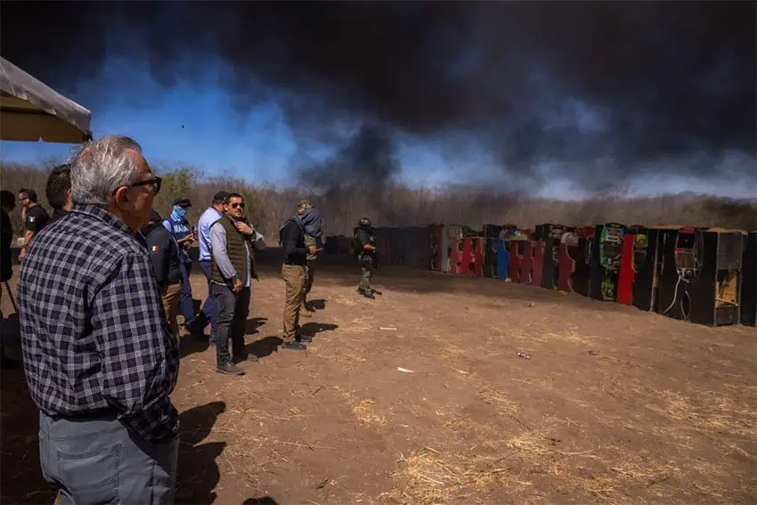 Sinaloa Gov. Rubén Rocha Moya looks on as illegal slot machines and other contraband are burned. 