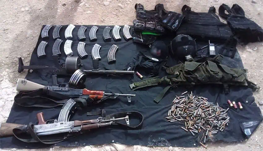 Guns, weapons and ammo confiscated by the National Guard in Zacatecas, laid out on a black cloth