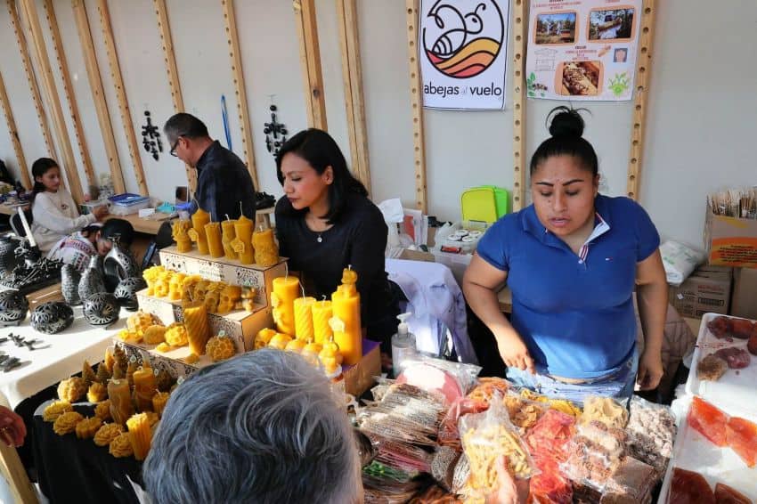 Workers sell food and candles in a temporary market in Mexico.