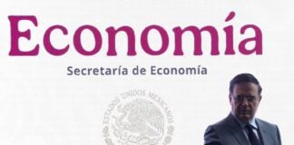 Marcelo Ebrard stood in front a giant sign