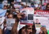 People holding signs seeking missing persons in Jalisco