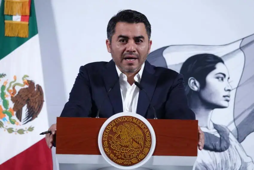 Efrain Morales Lopez, director of Mexico's National Water Commission, stands at the presidential podium at President Claudia Sheinbaum's daily press conference.