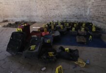 Shoes, clothes and backpacks marked with yellow forensic tags at a ranch in Teuchitlán, Jalisco