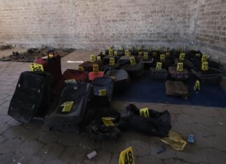 Shoes, clothes and backpacks marked with yellow forensic tags at a ranch in Teuchitlán, Jalisco