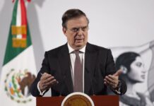 Economy Secretary Marcelo Ebrard stands at a podium