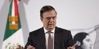 Economy Secretary Marcelo Ebrard stands at a podium