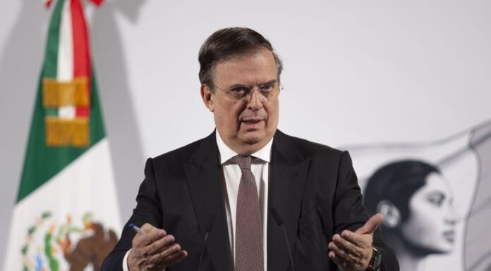 Economy Secretary Marcelo Ebrard stands at a podium