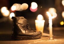 A boot next to a candle at a vigil for Mexico's disappeared