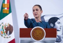 President Claudia Sheinbaum taking a question from a reporter during her daily press conference in the National Palace in Mexico City.