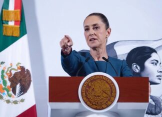 President Claudia Sheinbaum taking a question from a reporter during her daily press conference in the National Palace in Mexico City.