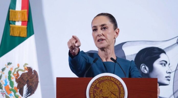 President Claudia Sheinbaum taking a question from a reporter during her daily press conference in the National Palace in Mexico City.