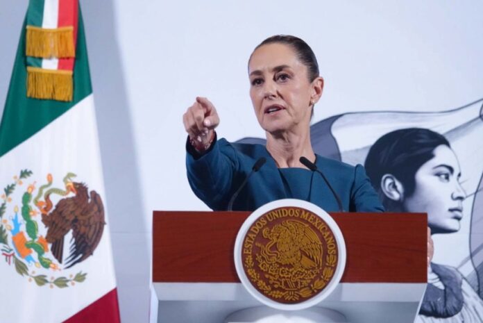 President Claudia Sheinbaum taking a question from a reporter during her daily press conference in the National Palace in Mexico City.