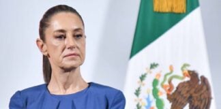 Mexico's President Claudia Sheinbaum at her daily press conference. She is listening to a reporter's question.