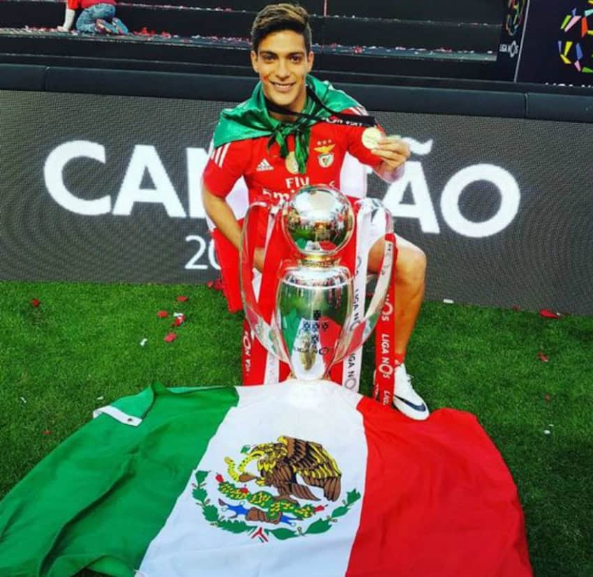 Raúl Jiménez at Benfica, celebrating winning the Portuguese title with a Mexican flag and a trophy