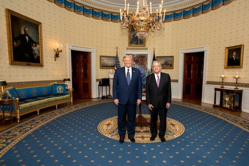 Donald Trump and Andres Manuel Lopez Obrador posing for a photo in a lavishly decorated room in the U.S. White House