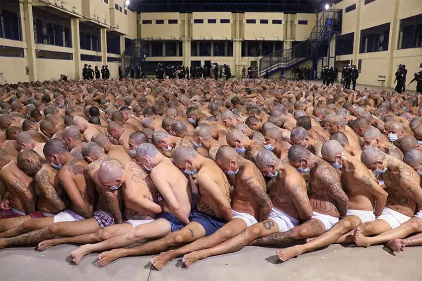 Hundreds of Salvadorean prisoners sit packed together with shaved heads.