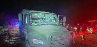 A bullet-riddled National Guard vehicle
