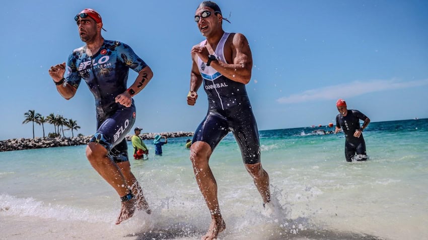 Ironman triathletes running across the Caribbean coast