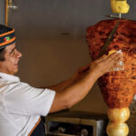 A man making tacos al pastor