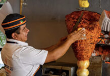 A man making tacos al pastor