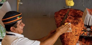 A man making tacos al pastor