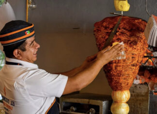 A man making tacos al pastor