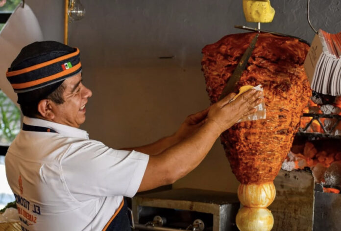 A man making tacos al pastor