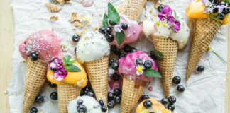 Several different flavors of ice cream in cones