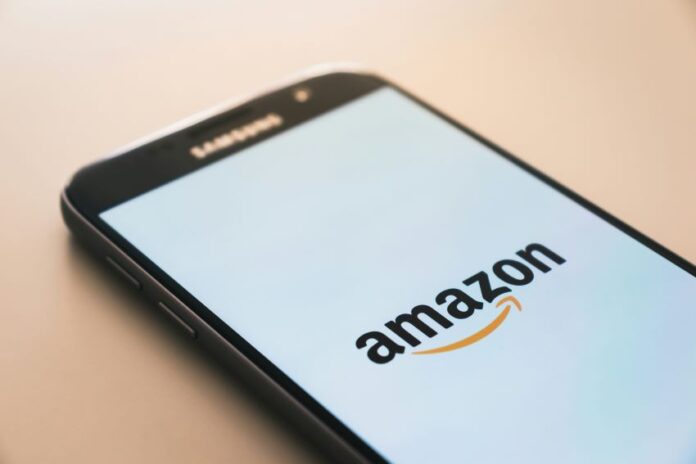 A cell phone displaying the amazon logo