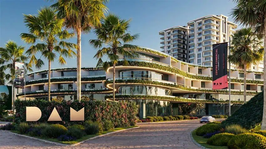 A rendering of the planned Mérida Art District shows a wide walkway next to palm trees with a modern four-story apartment building and a taller building behind it