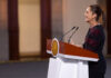 President Claudia Sheinbaum stands at a podium during her morning press conference