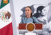 President Sheinbaum, looking serious, stands at the podium of her morning press briefing, where she cast doubt on some previous findings in the Teuchitlán extermination camp case