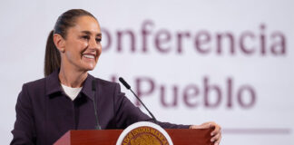 President Sheinbaum smiles from the podium at her morning press conference
