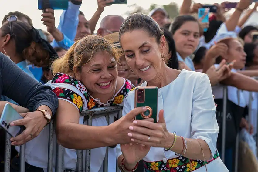 President Sheinbaum takes a phone selfie with a supporter