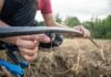A close-up shot shows a person adjusting an irrigation line in a field to reduce agricultural water waste