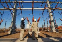 Construction workers at an electrical station.