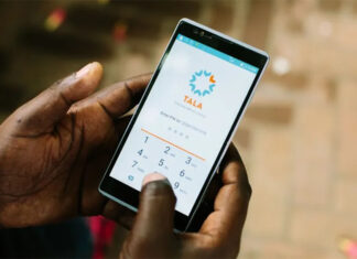Hands hold a phone with the Tala microlending application open