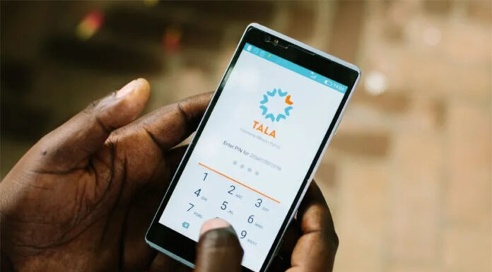 Hands hold a phone with the Tala microlending application open