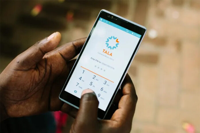 Hands hold a phone with the Tala microlending application open