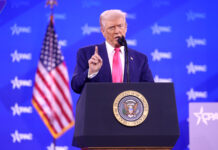 Trump stands at podium shaking his finger