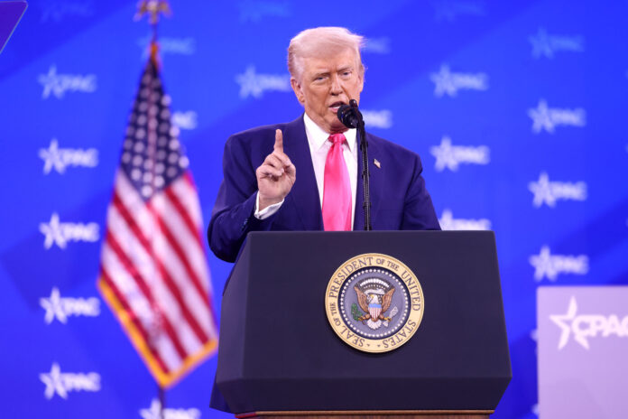 Trump stands at podium shaking his finger