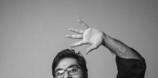 Black and white photo of a man waving