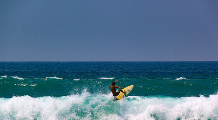 A surfer performs a trick in a wave at Zicatela Beach in Puerto Escondido, the 14th World Surfing Reserve