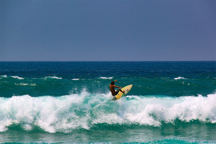 A surfer performs a trick in a wave at Zicatela Beach in Puerto Escondido, the 14th World Surfing Reserve