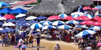 A beach crowded with umbrellas and tourists in Acapulco