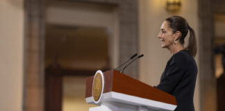 President Claudia Sheinbaum stands at a podium