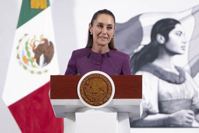 President Sheinbaum stands at a podium during her morning press conference