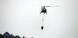 A firefighting helicopter flies over Tepoztlán national park