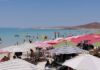 People sunbathing under beach umbrellas on a Baja Caliornia Sur beach